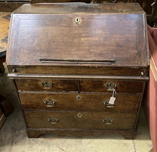 A mid 18th century oak bureau, with well, width 90cm depth 56cm height 99cm